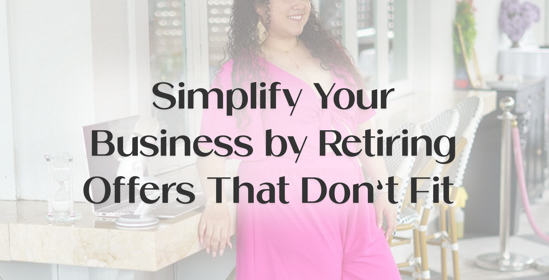 Entrepreneur working calmly at a laptop with a microphone, representing business alignment through simplifying offers that no longer fit long-term goals.