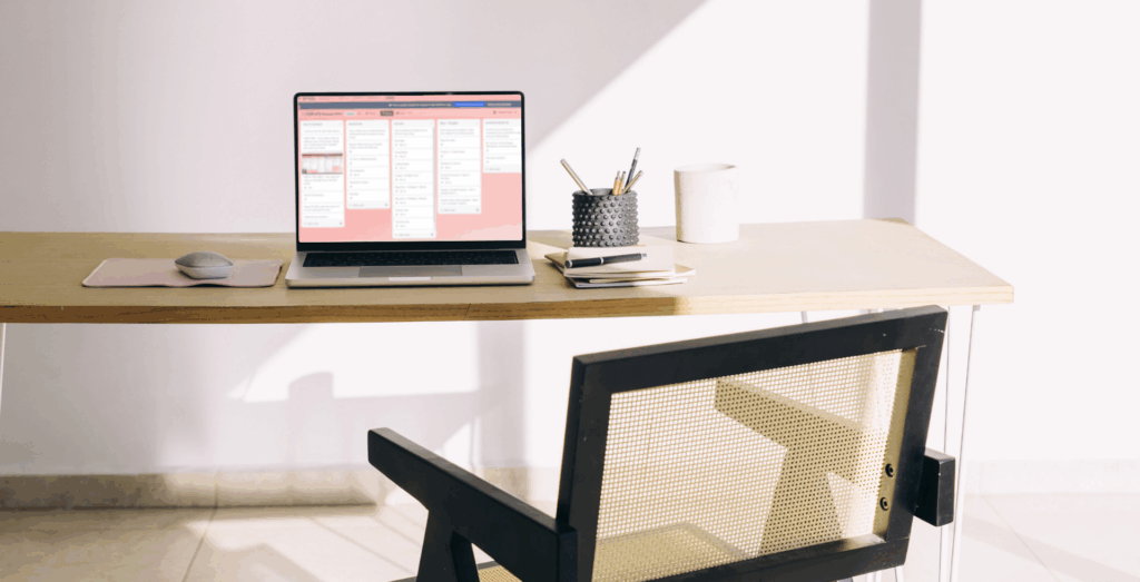 Laptop displaying Trello board on a clean desk, illustrating how to use Trello to organize your business with Trello boards for business.