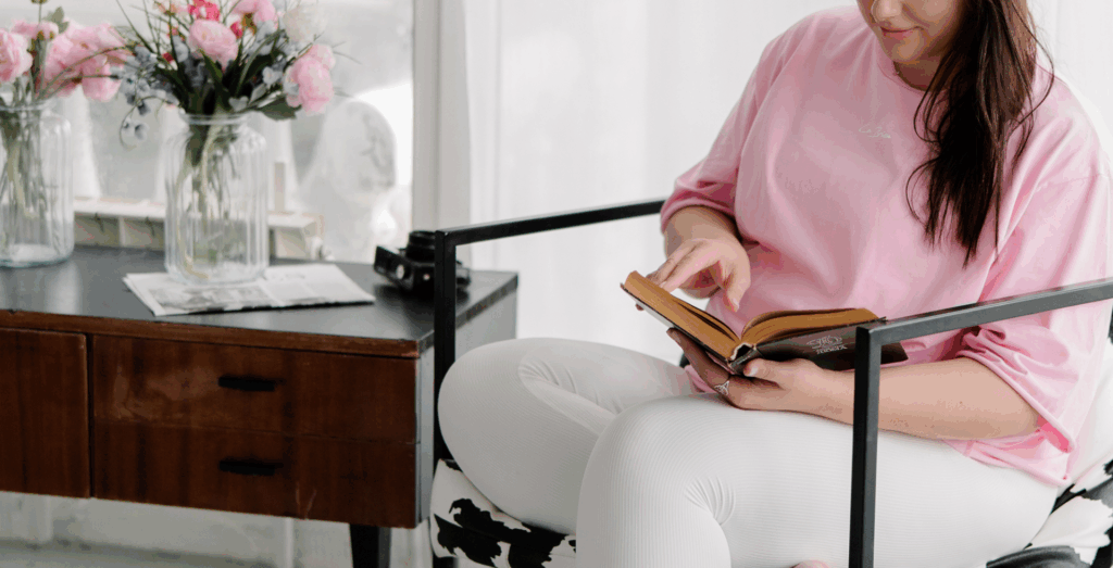 Entrepreneur reading and reflecting in a quiet space, representing a consistency mindset shift, self improvement, and how to be consistent in business through simple, sustainable habits.