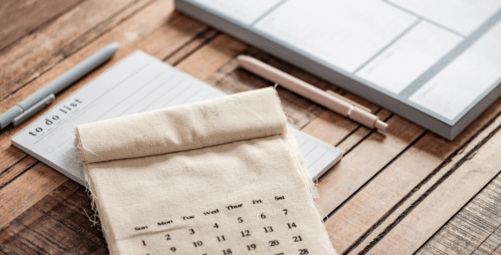 Planner, calendar, and to-do list on desk, representing business consistency, self improvement, and practical productivity tips for solopreneurs building consistent habits for business success.