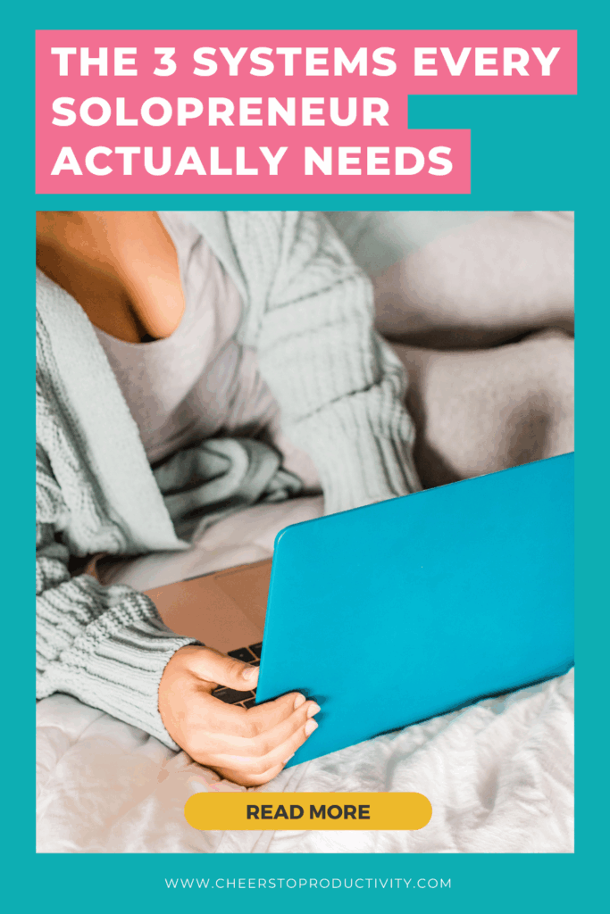 Pinterest pin graphic for overwhelmed solopreneurs featuring a woman working on a laptop in bed with the text “The 3 Systems Every Solopreneur Actually Needs” about simple systems for business and life.