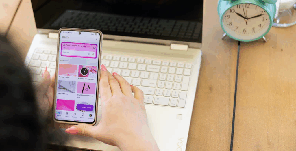 Solopreneur using business and life systems on a phone and laptop to manage tasks, showing sustainable systems for solopreneurs and systems for real life that support daily routines and productivity.