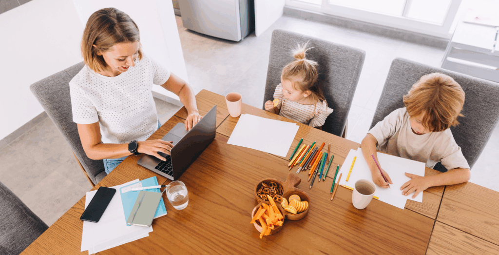 Solopreneur working from home while caring for children, illustrating the invisible workload and mental load involved in balancing business and family life through intentional routines, supportive habits, healthy boundaries, and realistic home systems for solopreneurs who often feel overwhelmed.