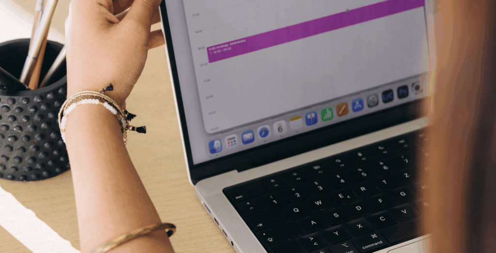 Woman at laptop reviewing calendar, feeling unproductive and trying to manage her seasons of life